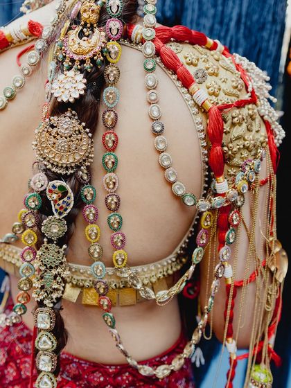 A close-up on the intricate details of the jewelry and hair adornments. The makeup on the back and shoulders is just as important, and I ensure an even, flawless finish all over for a complete bridal look.