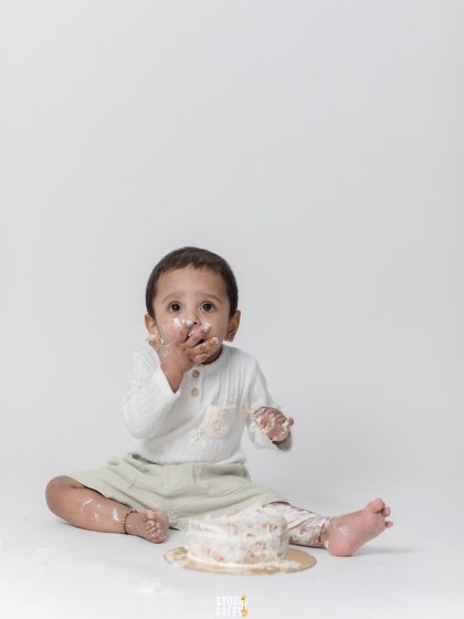 "Wasn't me!" A cute shot of the baby with frosting on his face.