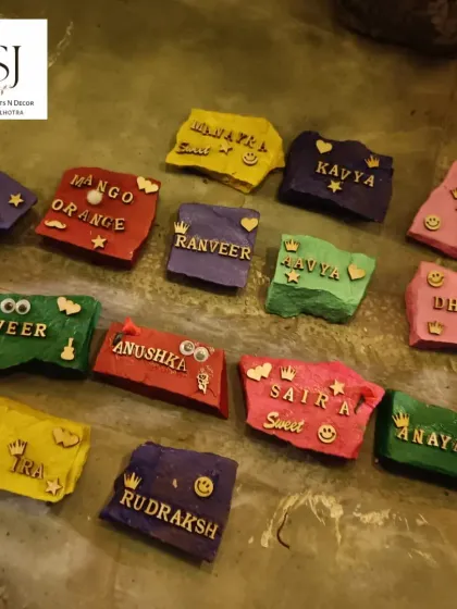 A beautiful display of personalized stone art created by guests at a fairy-themed party. This is another unique and creative activity we offer.