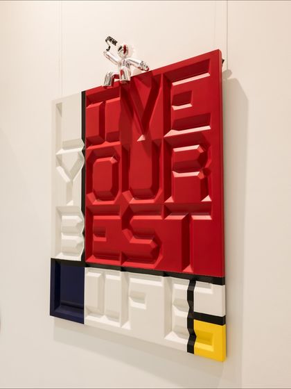 A side angle of the "Live Your Best Life" piece, showing the depth of the carved letters and the geometric forms.