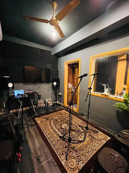 This is one of our professionally treated recording and jamming rooms. It's fully equipped with studio monitors, microphones, and a comfortable setup, creating the perfect vibe for you to practice and create.