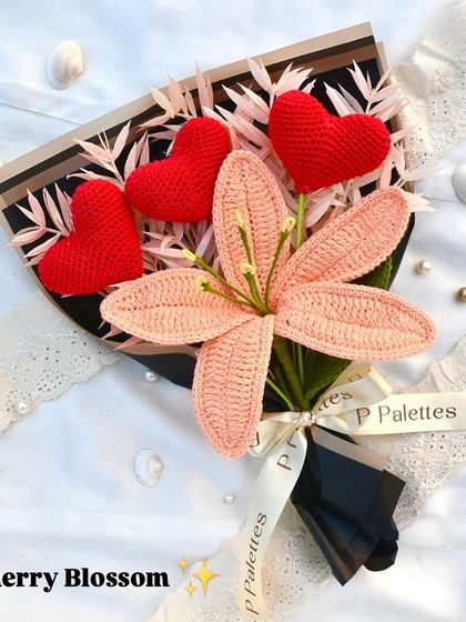 Our 'Cherry Blossom' bouquet is a striking combination of a delicate pink lily and three crochet hearts, perfect for a declaration of love.