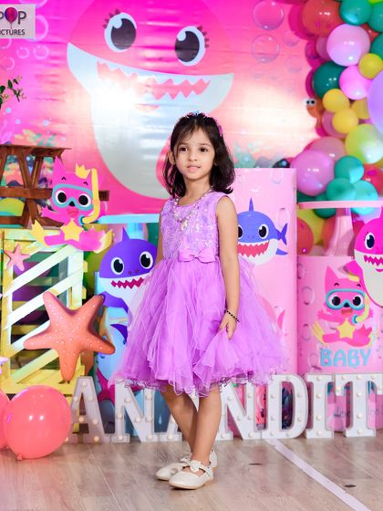 A thrilling 'Dinosaur' themed birthday party, with prehistoric backdrops, dinosaur cutouts, and lush greenery, transporting guests to a Jurassic world.