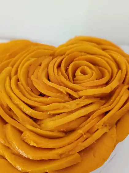 Here is a close-up of the detail in the mango rose topping. This view highlights the delicate craftsmanship and the freshness of the ingredients I use in my signature no-bake cheesecakes.