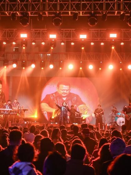 The entire band is visible on the giant screen, making sure everyone in the massive crowd gets a front-row experience. A look at our professional stage production.