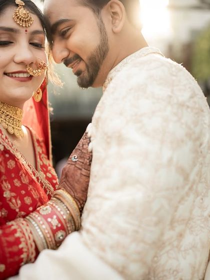 A tender, sun-flared portrait of the couple after their 'first look'. These are the moments filled with pure, unadulterated love.