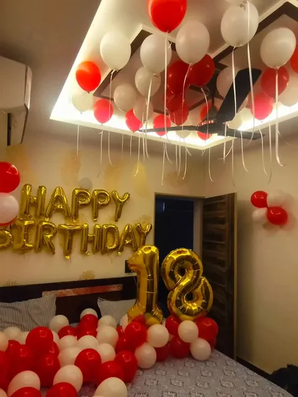 An 18th birthday room decoration. We used a simple yet classic red and white theme with balloons on the floor and ceiling, and large "18" foil balloons to mark the special occasion.