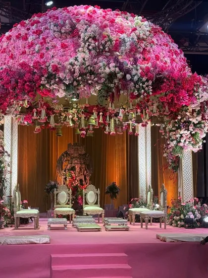 This wedding mandap was a dream brought to life, a blossoming dome of countless pink and white florals creating a sacred canopy. The sheer scale and density of the flowers were designed to envelop the couple in an atmosphere of pure romance, making their sacred vows feel like a moment suspended in a floral heaven.