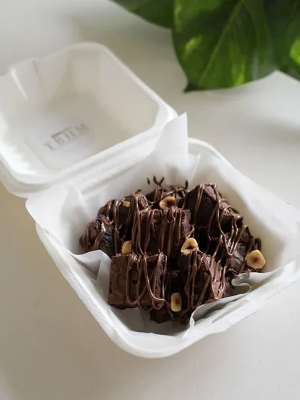 A box of my Nutella Ferrero Rocher brownies, packed and ready to go in eco-friendly packaging. These are perfect for a quick treat or a small gift.