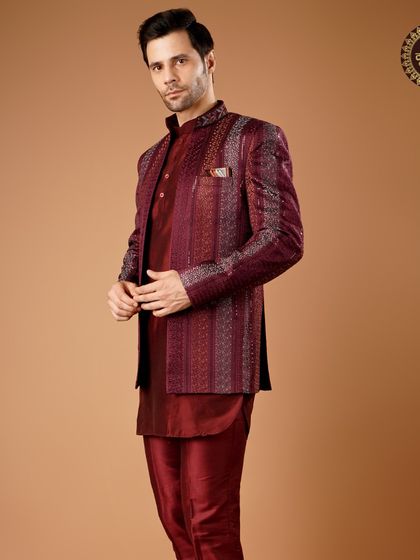 Look your best on the big day with this deep maroon Indo-Western outfit. The structured jacket and matching trousers create a cohesive and royal look.