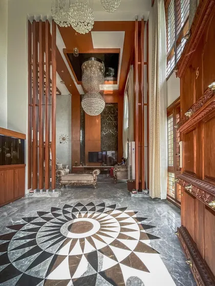 Bespoke details are a signature of our work. For this villa's entrance, we designed and executed a custom geometric mandala pattern using an intricate inlay of black and grey marble, creating a stunning and memorable first impression.