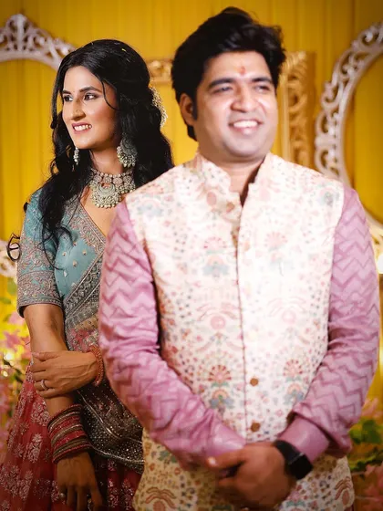 A candid shot of the couple enjoying their engagement ceremony. The genuine smiles and relaxed posture make this a beautiful memory.