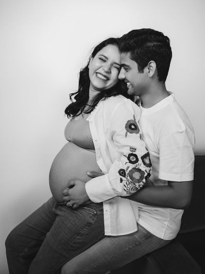 This maternity shot speaks volumes about the joy, excitement, and love that comes with expecting a new life, captured in a candid black and white style.