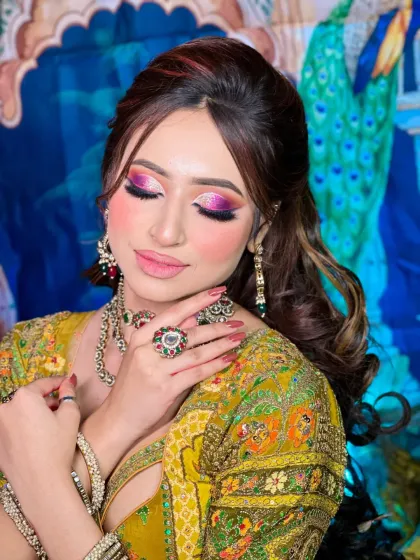 A close-up of the colorful eye makeup. The blend of pink, purple, and gold creates a beautiful sunset effect on the lids.