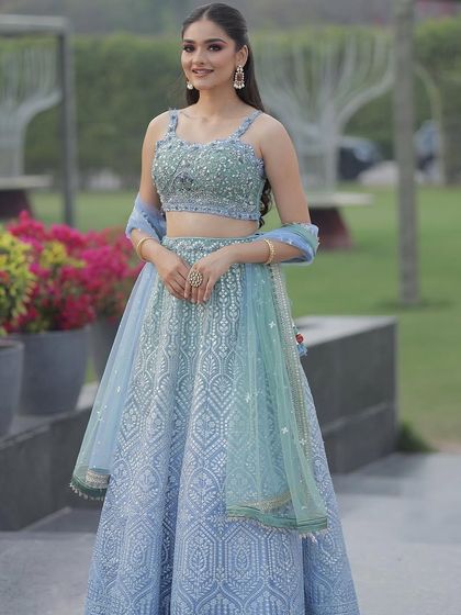 Our model looking radiant in the ice blue lehenga. The simple, strappy blouse and flowing skirt create a timeless and flattering silhouette.