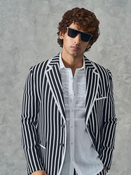 A close-up of our black and white striped suit, showing the clean piping detail on the lapel.