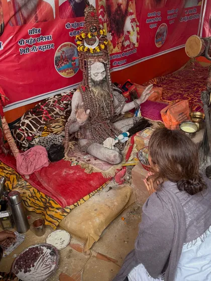 Receiving blessings from a Naga Sadhu at his camp. The opportunity to connect with such deeply devoted ascetics is a rare and powerful part of the Kumbh Mela.