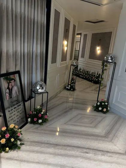 Even the most intimate celebrations deserve grand details. We transformed this home's hallway for a pre-wedding function with elegant floral arrangements, personalized welcome signs, and subtle touches like disco balls for a hint of glamour.