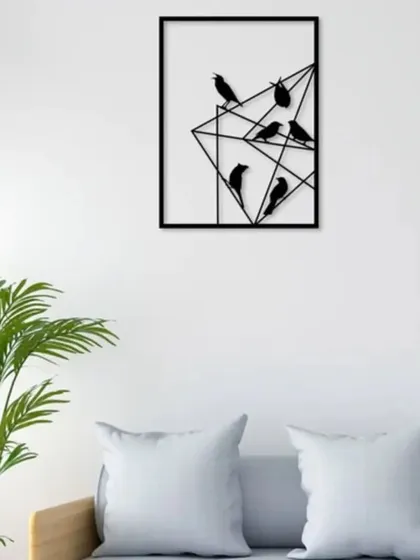 This geometric metal wall art features a flock of birds perched on abstract lines. The clean, modern design in a black finish adds a touch of nature-inspired graphic art to your living space.