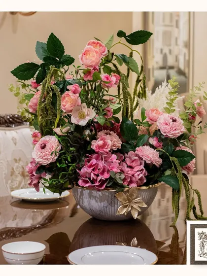 A beautiful floral arrangement can transform a room. This luxurious centerpiece, with its mix of pinks and greens, is designed to bring timeless elegance to a dining or console table, making any gathering feel more special and sophisticated.