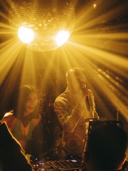 Sharing the DJ booth with a live vocalist under the golden light of a disco ball. These collaborations create unforgettable, one-of-a-kind performances.