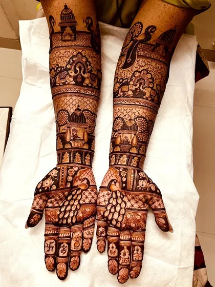 An example of a grand, full-coverage bridal design. We've included temple motifs, peacocks, and intricate jaal (net) patterns to create a truly royal look.