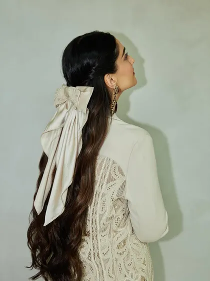 The back view of Sonam Kapoor's look, focusing on the large, elegant bow that adds a dramatic yet soft touch to the hairstyle.