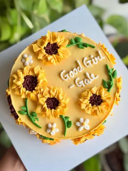 Sunshine, sweetness, and a little bit of sass. This bright yellow cake is adorned with beautifully piped buttercream sunflowers.