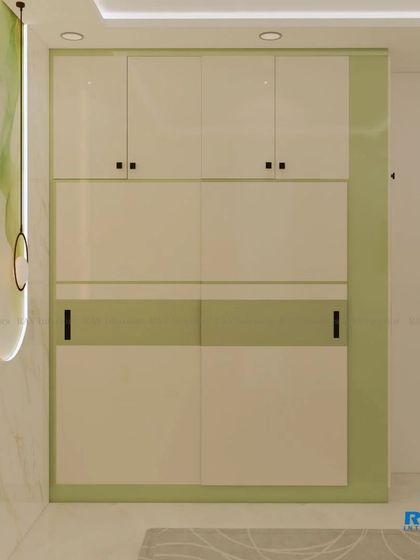 The sliding wardrobe in the green-themed bedroom, featuring a simple and modern two-tone design.