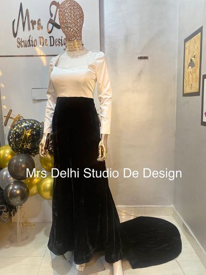 The full look of our black and white trail gown. This custom piece combines classic colors with a modern silhouette for a truly sophisticated statement.