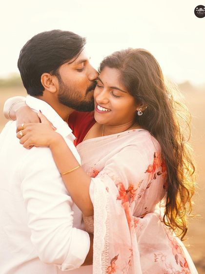 A sweet and romantic kiss on the cheek, backlit by the beautiful golden hour sun. This kind of lighting creates a magical, dream-like effect.