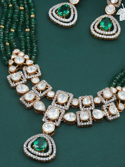 A vision in green, this necklace is where modern grace meets timeless grandeur. Uncut polki diamonds are set against a cascade of deep green emerald beads, centered with magnificent emeralds. This is a statement of sophisticated luxury, perfect for grand celebrations and evening soirées.