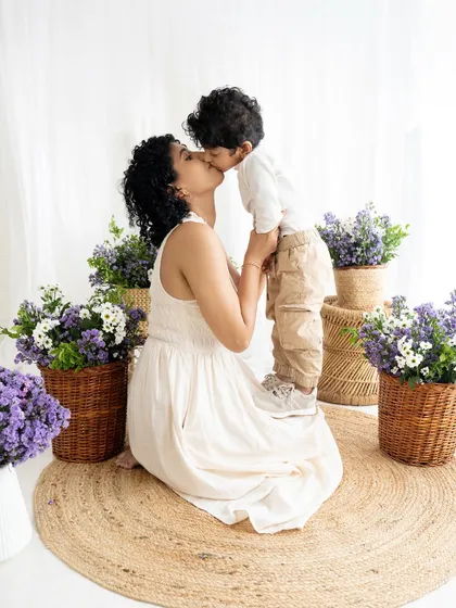 A tender kiss during a 'Mommy and Me' session. These quiet, loving moments are just as important as the big smiles, creating timeless portraits of motherhood.