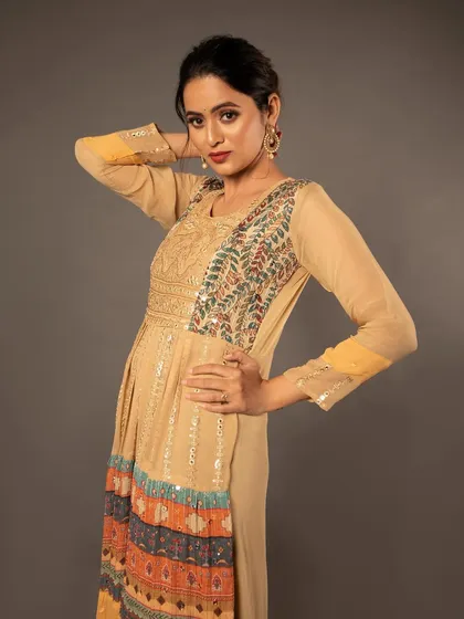 A confident pose that showcases the full design of the ethnic dress.