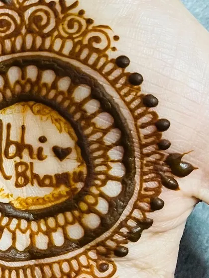 The names of the couple, 'Abhi' and 'Bhanu', are written in the heart of this engagement mehendi design.