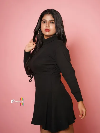 A duplicate of 154, a full-length studio shot of a model in a black dress.