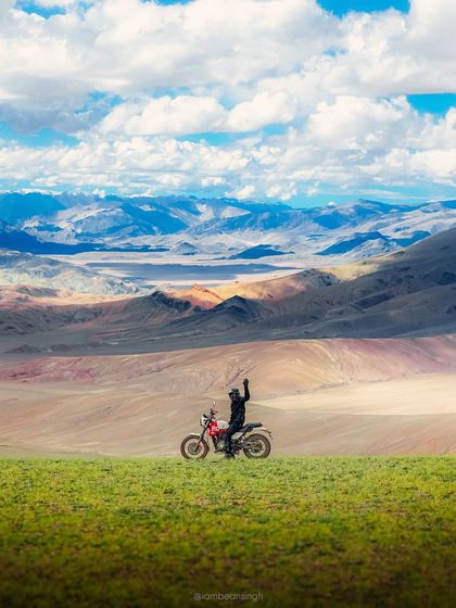 A lone rider stands against the immense, layered landscape of Ladakh. This shot, taken during the Himalayan Odyssey with Royal Enfield, is all about scale and the spirit of exploration. It’s a hero image that can define a campaign.