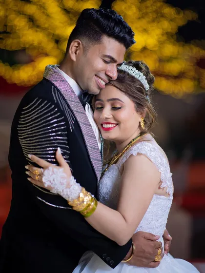 A happy and affectionate embrace between a newly married couple at their reception, capturing their post-wedding glow.