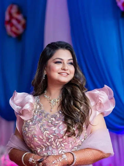 A lovely engagement ceremony look. The makeup is subtle and glowy, paired with soft open waves for a romantic and modern feel.