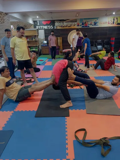 A full view of our partner stretching class. You can see the energy and connection as students help each other move deeper into the postures.