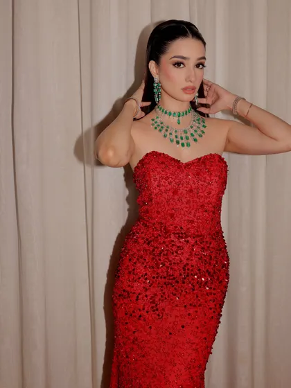 A beautiful shot capturing the texture of the sequined gown and the elegance of the high ponytail.