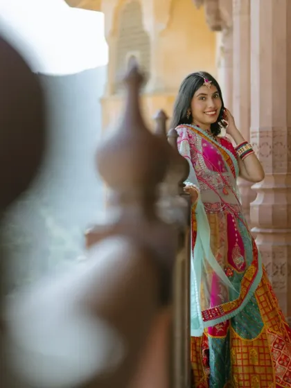 A beautiful solo portrait of the bride, framed by the textures and architecture of Amber Fort. I make sure to capture individual shots that highlight your personality and the details of your attire.