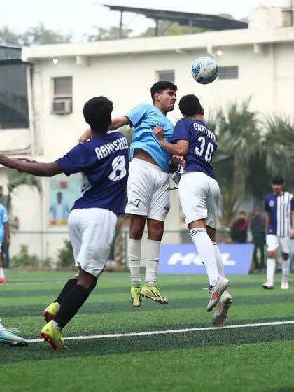 "I learned all about life with a ball at my feet." An intense aerial battle for a header during a crucial match moment.