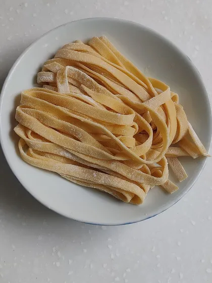 Strands of handmade tagliatelle. There is no comparison to the texture and flavor of pasta made fresh with your own hands.