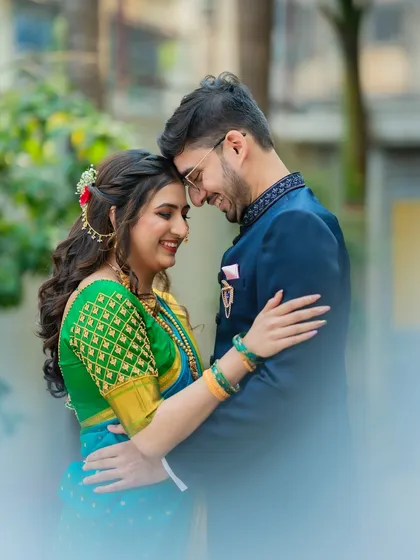 A soft and dreamy close-up of Ameya and Gautami. The foreground blur adds a cinematic feel, drawing all the attention to their happy and intimate moment.