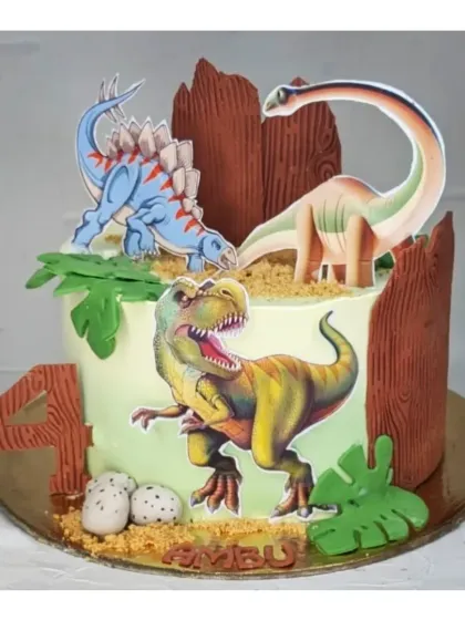 A dinosaur-themed cake with a fresh mango flavor. This design features different types of dinosaurs and edible dirt, perfect for a little explorer's birthday.