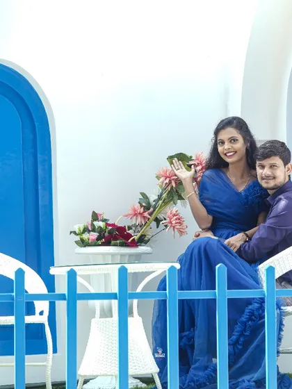 This couple is all smiles on the balcony of the Greek-inspired studio set. The vibrant blue and white colors make the photos pop.