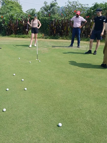 A group of beginners learns the basics of putting during a complimentary golf orientation workshop. Our coaches make sure the introduction to the sport is fun and accessible.