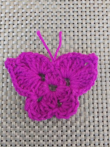 A single butterfly applique. This versatile piece can be made into a keychain, hairclip, bookmark, or anything else you can imagine.