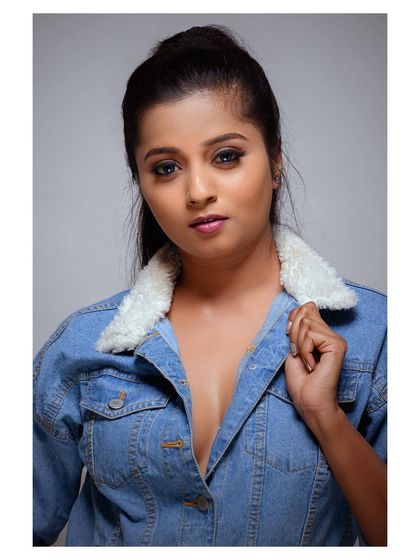 A bold and stylish portrait in a denim jacket. The pose is confident and the look is modern and edgy.